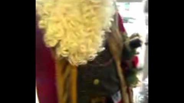 'An Old Fashion Santa Claus Standing By A Chritmas Tree At Are Laundromat'