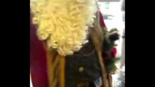 'An Old Fashion Santa Claus Standing By A Chritmas Tree At Are Laundromat'